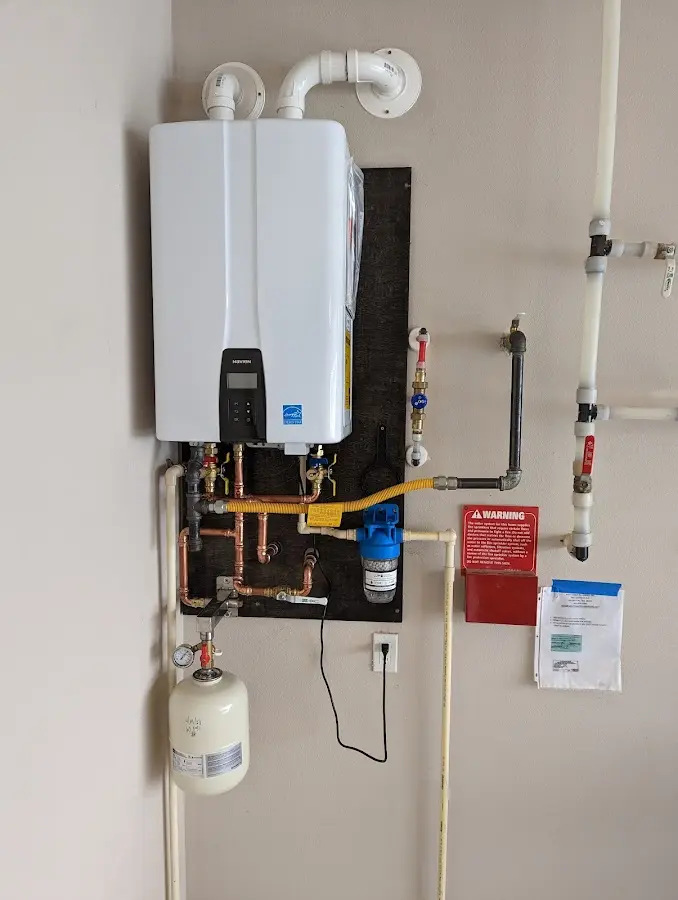 Professional plumber installing copper piping in a Grayson home